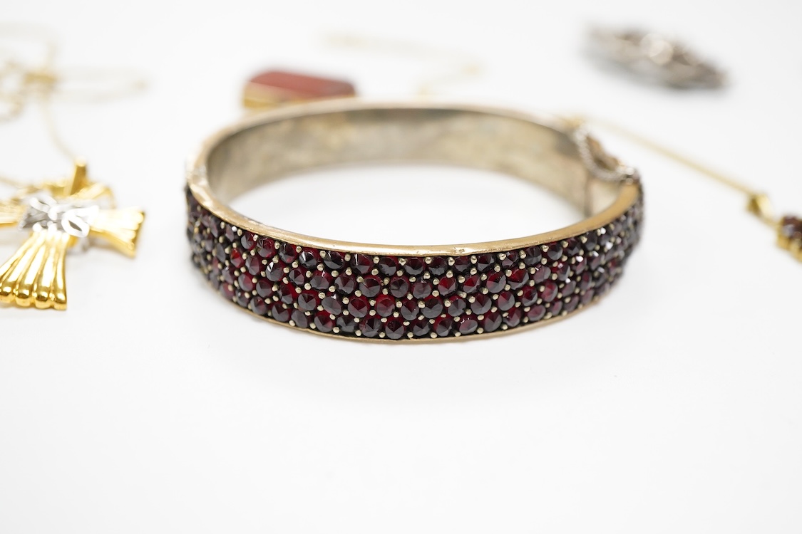 An 800 standard gilt white metal and garnet cluster set oval pendant, 18mm, on a 585 yellow metal fine link chain, 2.5 grams, a gilt white metal and garnet cluster set hinged bangle, two white metal brooches including on